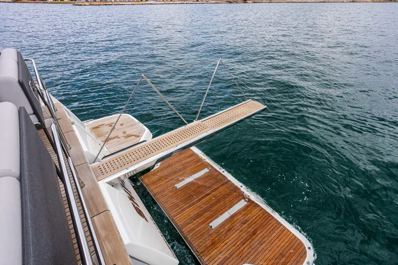 Yacht Photos Pics Luxury yacht Prestige M48 2024 with extended swim platform on calm water.