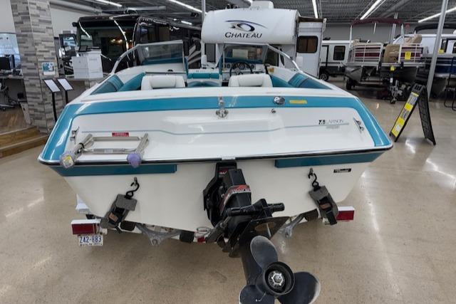 1991 Larson All American 170 boat displayed indoors, showcasing rear view and motor.