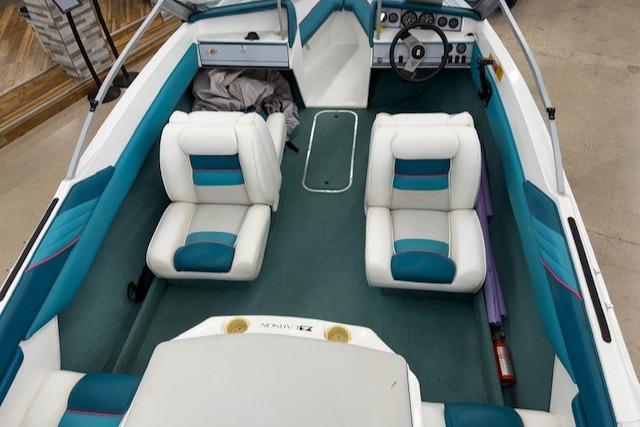 1991 Larson All American 170 boat interior with teal and white seating.