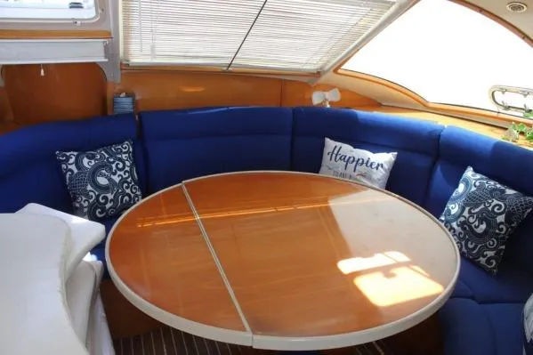 Jobsite Yacht Photos Pics Luxurious 2006 Alliaura Marine Privilege 435 EZC yacht interior with blue seating and round table.