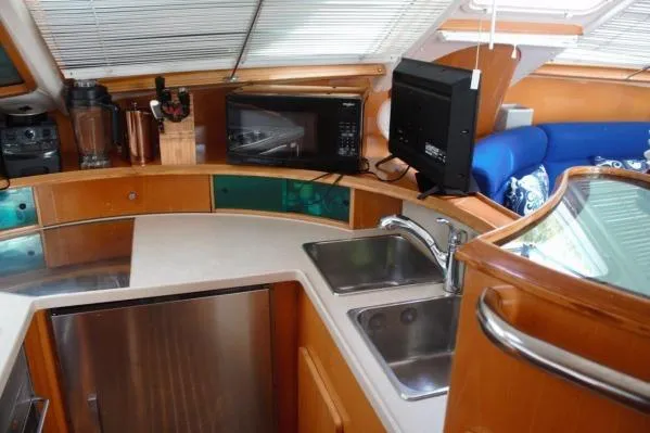 Jobsite Yacht Photos Pics 2006 Alliaura Marine Privilege 435 EZC yacht kitchen with modern appliances and wooden cabinetry.