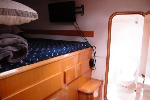 Jobsite Yacht Photos Pics 2006 Alliaura Marine Privilege 435 EZC cabin with bed, TV, and bathroom view.