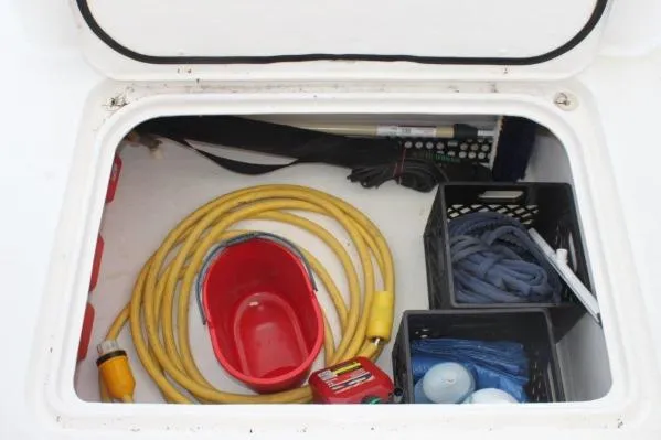 Jobsite Yacht Photos Pics Storage compartment of 2006 Alliaura Marine Privilege 435 EZC with cables, bucket, and supplies.