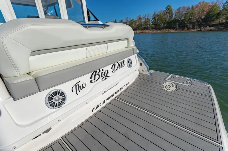  Yacht Photos Pics 2021 Regal 36 Grande Coupe boat with "The Big Dill" name, docked on a serene lake.