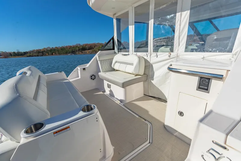  Yacht Photos Pics 2021 Regal 36 Grande Coupe boat interior with white seating and lake view.