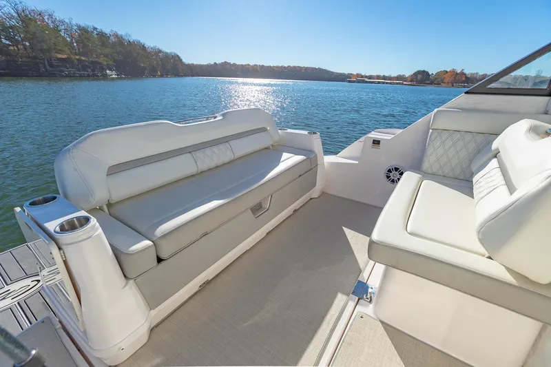  Yacht Photos Pics 2021 Regal 36 Grande Coupe boat interior with white seating, overlooking a serene lake.
