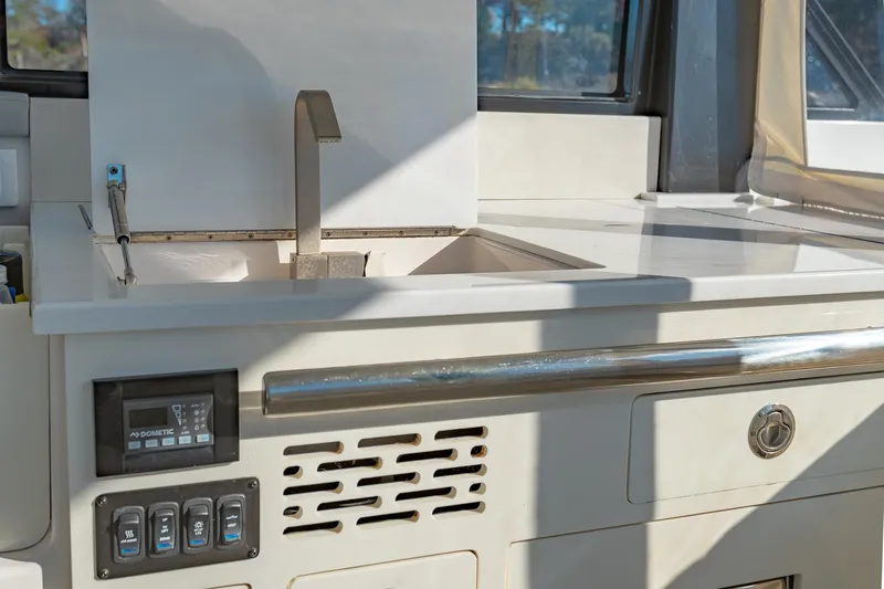  Yacht Photos Pics 2021 Regal 36 Grande Coupe yacht kitchen with modern sink and control panel.