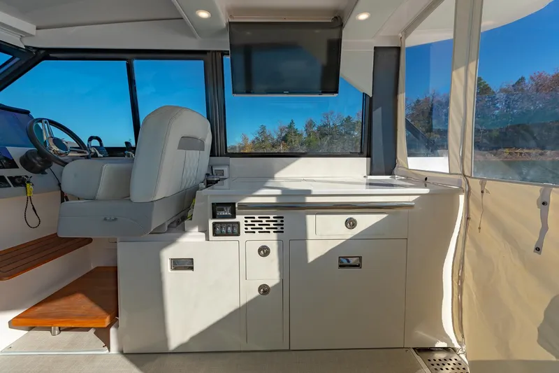  Yacht Photos Pics 2021 Regal 36 Grande Coupe interior with helm, seating, and panoramic windows.