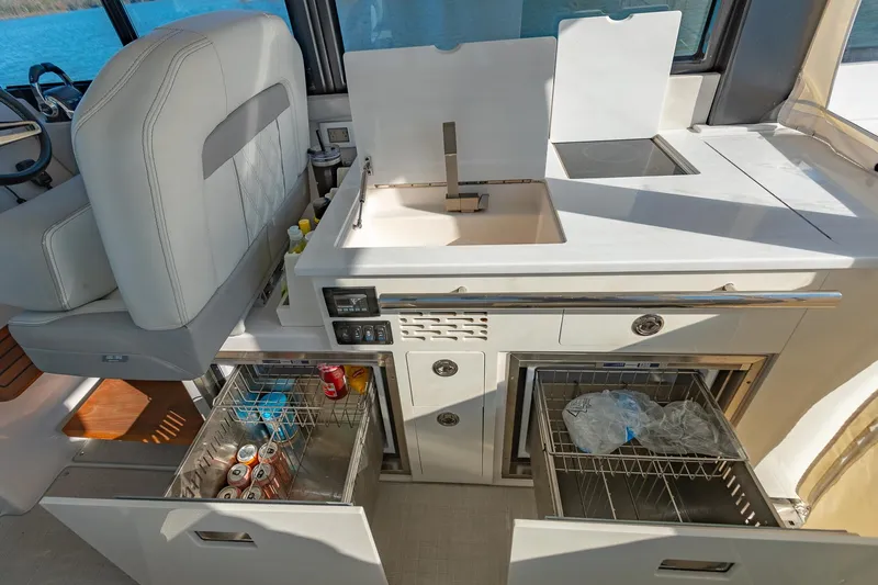  Yacht Photos Pics 2021 Regal 36 Grande Coupe yacht interior kitchen with sink and storage drawers.