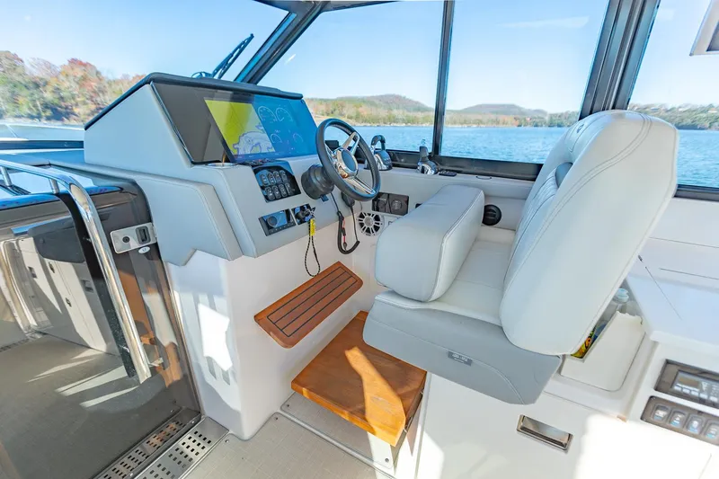  Yacht Photos Pics Interior cockpit of 2021 Regal 36 Grande Coupe with modern controls and seating.