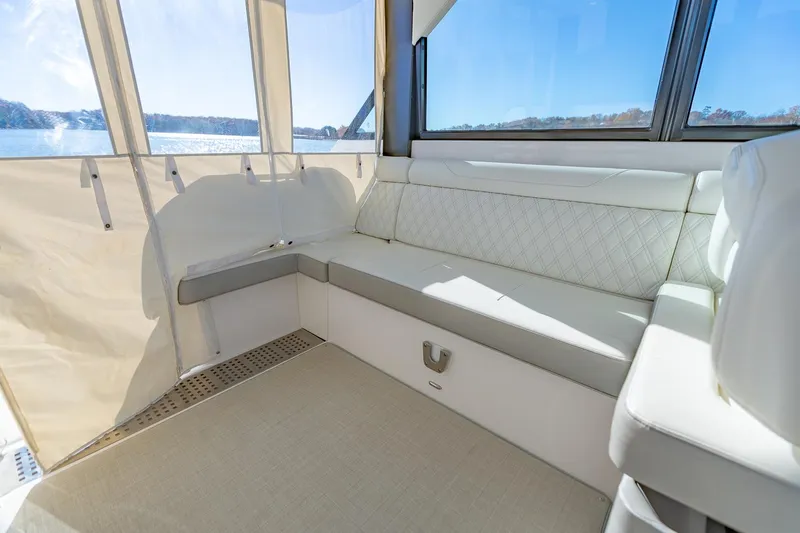  Yacht Photos Pics Luxurious interior of 2021 Regal 36 Grande Coupe yacht with white seating and scenic view.