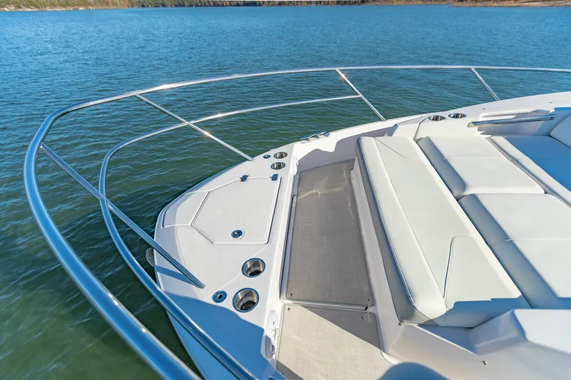  Yacht Photos Pics 2021 Regal 36 Grande Coupe boat deck with seating, on calm water.