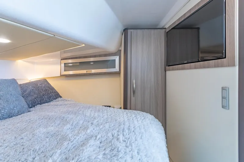  Yacht Photos Pics Interior cabin of 2021 Regal 36 Grande Coupe with cozy bedding and modern design.