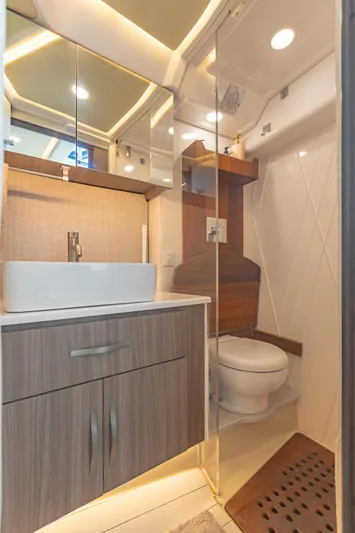 Yacht Photos Pics Luxurious bathroom in 2021 Regal 36 Grande Coupe yacht with modern fixtures and wood accents.