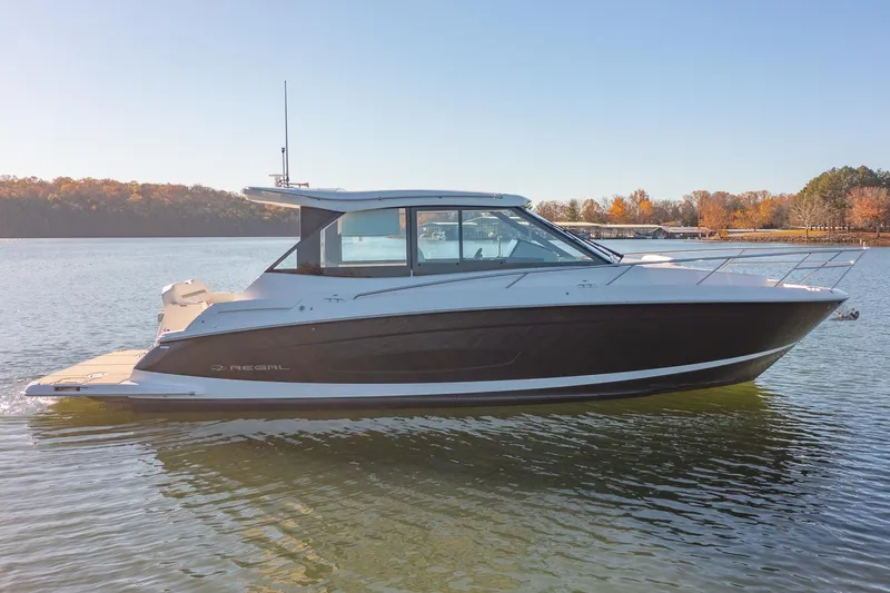  Yacht Photos Pics 2021 Regal 36 Grande Coupe boat on calm lake with autumn trees.