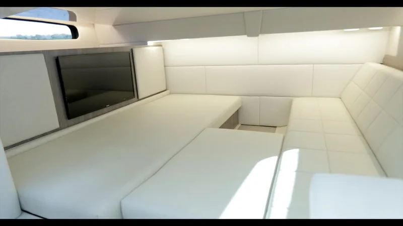  Yacht Photos Pics Luxurious interior of 2021 Regal 36 Grande Coupe with white seating and TV.