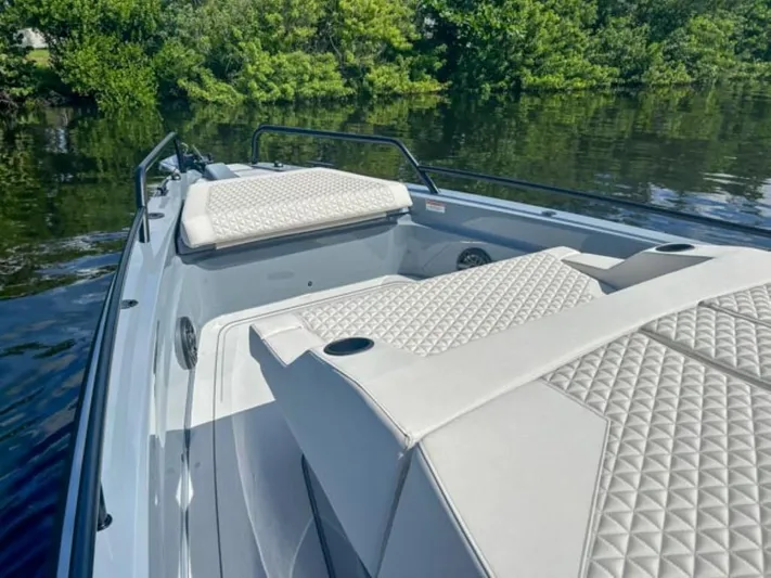  Yacht Photos Pics 2024 BRABUS Shadow 1000XC luxury boat with quilted seating on a serene waterway.