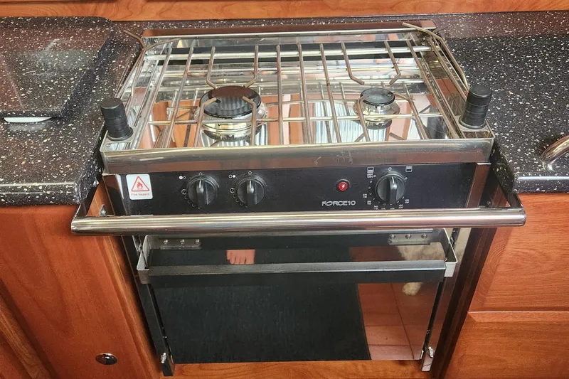 Antares Yacht Photos Pics Stove and oven in 2011 Hunter 39 yacht kitchen with wooden cabinetry.