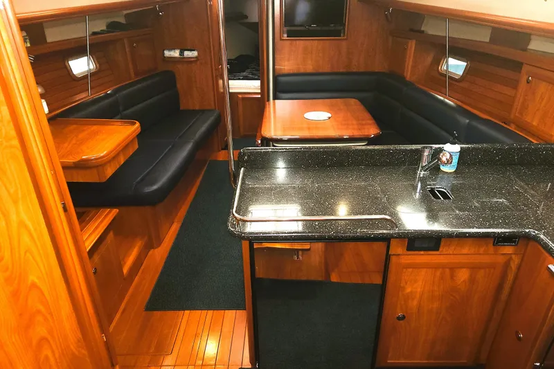 Antares Yacht Photos Pics Luxurious interior of 2011 Hunter 39 yacht with wood finish and modern amenities.