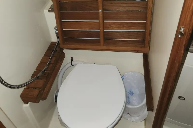 Antares Yacht Photos Pics Compact bathroom in 2011 Hunter 39 sailboat with wooden accents and toilet.