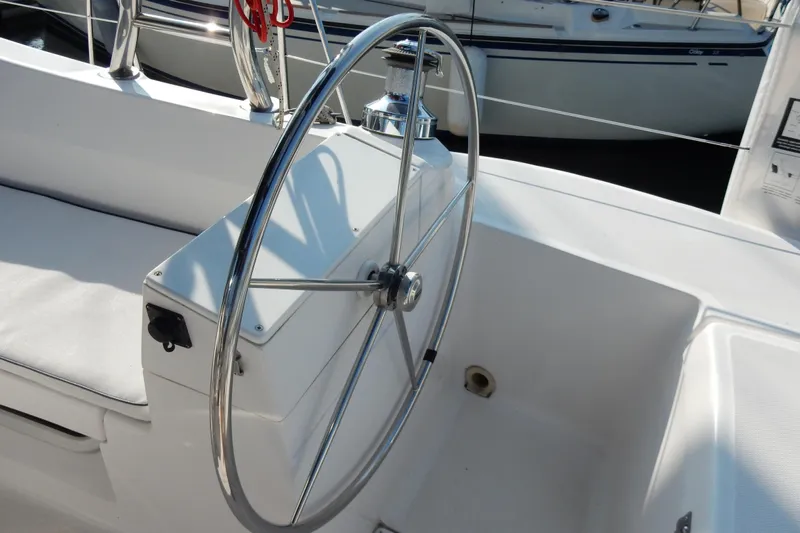 Antares Yacht Photos Pics Steering wheel of a 2011 Hunter 39 sailboat, featuring a sleek, modern design.