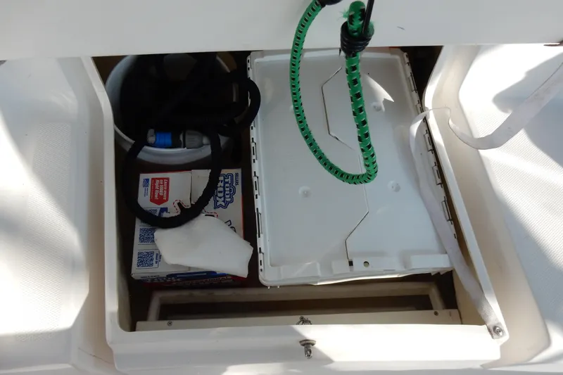 Antares Yacht Photos Pics Storage compartment in a 2011 Hunter 39 boat with cleaning supplies and equipment.