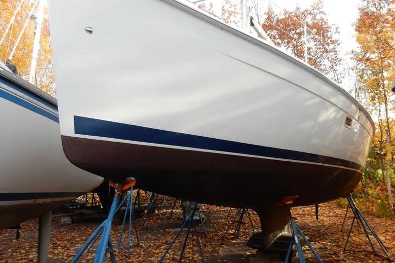 Antares Yacht Photos Pics 2011 Hunter 39 sailboat on stands, surrounded by autumn leaves.