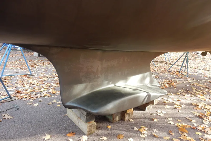 Antares Yacht Photos Pics Keel of 2011 Hunter 39 sailboat on blocks, surrounded by autumn leaves.