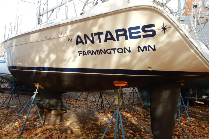 Antares Yacht Photos Pics Sailboat "Antares" Hunter 39, 2011 model, on stands with autumn leaves.