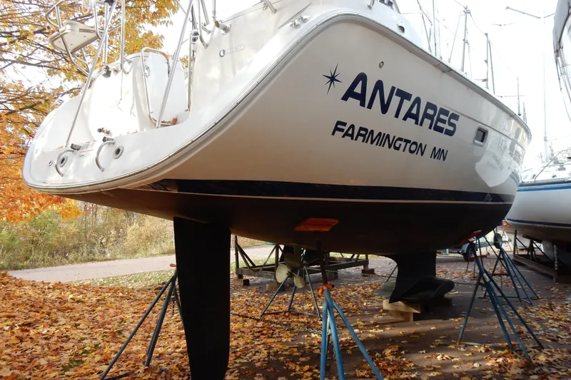 Antares Yacht Photos Pics 2011 Hunter 39 sailboat "Antares" on stands, surrounded by autumn leaves.