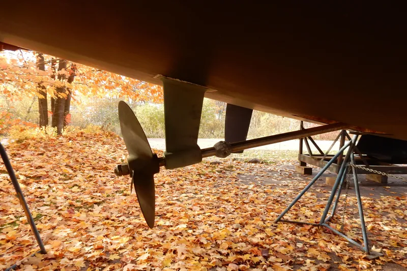 Antares Yacht Photos Pics Propeller of 2011 Hunter 39 sailboat on autumn leaves background.