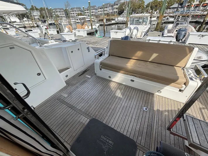 Sawbones Yacht Photos Pics Fairline Squadron 42 yacht deck, 2015 model, featuring seating and docked at a marina.