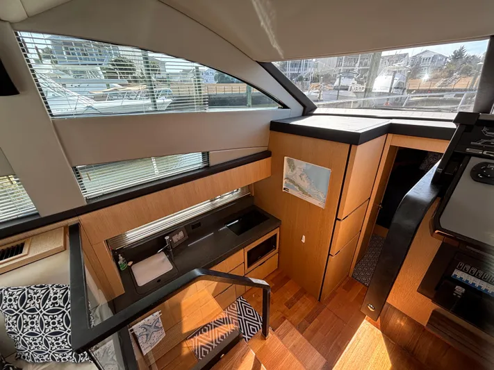 Sawbones Yacht Photos Pics Interior of 2015 Fairline Squadron 42 yacht, featuring modern kitchen and stylish wood finishes.
