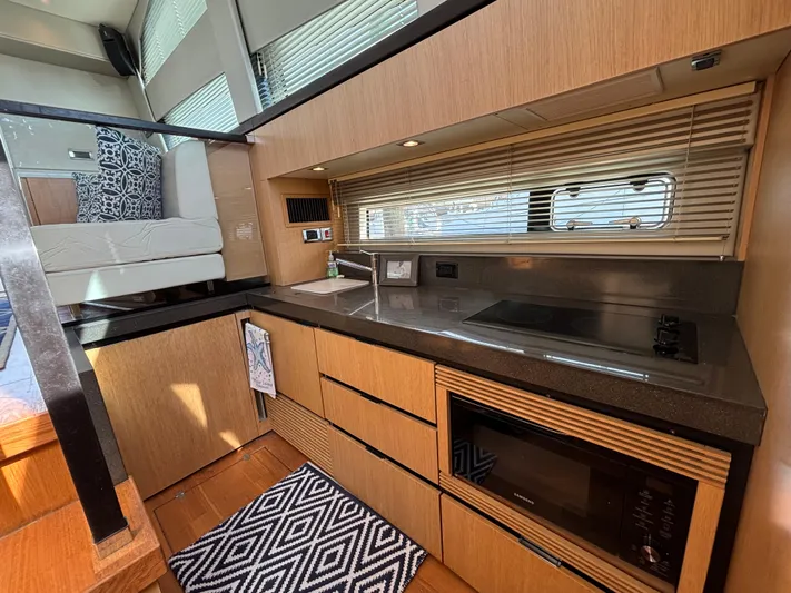 Sawbones Yacht Photos Pics Modern kitchen interior of 2015 Fairline Squadron 42 yacht with sleek design and appliances.