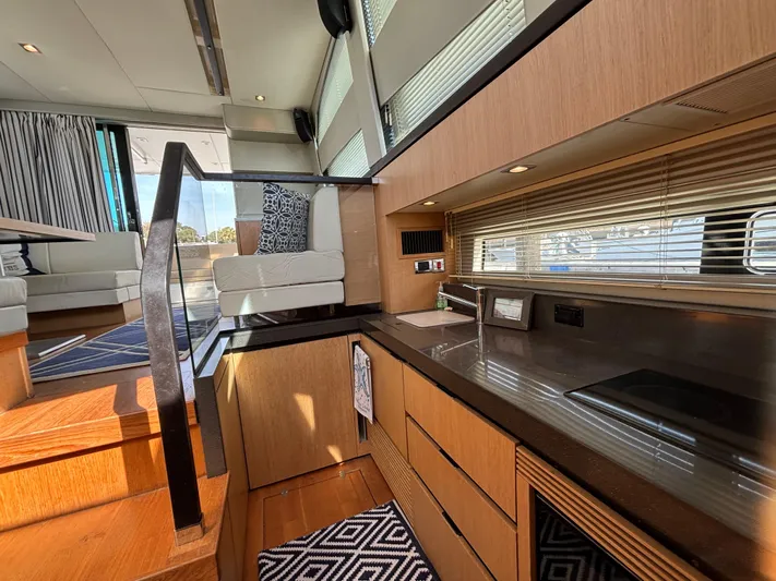 Sawbones Yacht Photos Pics Luxurious interior of 2015 Fairline Squadron 42 yacht with modern kitchen and seating area.