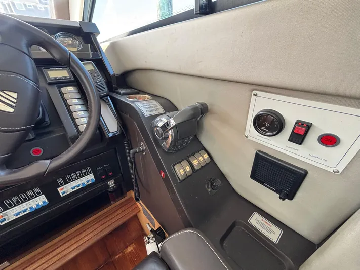 Sawbones Yacht Photos Pics Control panel of a 2015 Fairline Squadron 42 yacht, featuring steering wheel and switches.