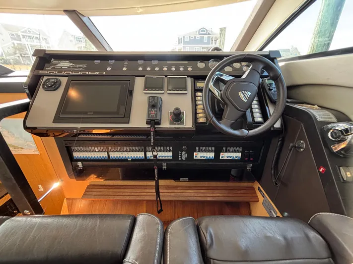 Sawbones Yacht Photos Pics 2015 Fairline Squadron 42 yacht helm with steering wheel and control panel.