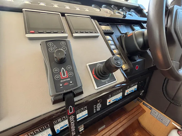 Sawbones Yacht Photos Pics Control panel of 2015 Fairline Squadron 42 yacht with navigation screens and joystick.