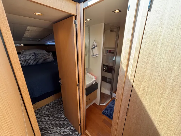 Sawbones Yacht Photos Pics Interior of 2015 Fairline Squadron 42 yacht, featuring bedroom and bathroom with wooden finishes.