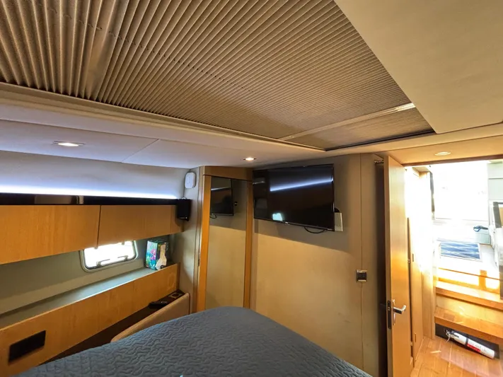 Sawbones Yacht Photos Pics Interior of 2015 Fairline Squadron 42 yacht, featuring a cozy bedroom with modern amenities.