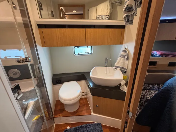 Sawbones Yacht Photos Pics Luxurious bathroom in 2015 Fairline Squadron 42 yacht, featuring modern fixtures and elegant design.