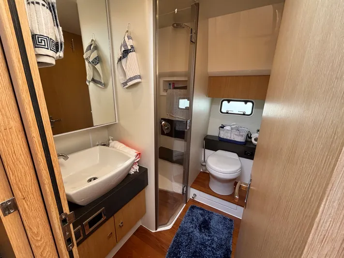 Sawbones Yacht Photos Pics Luxurious bathroom in 2015 Fairline Squadron 42 yacht with modern fixtures and elegant design.