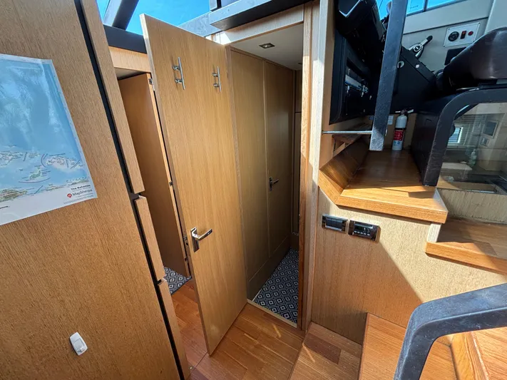 Sawbones Yacht Photos Pics Interior of 2015 Fairline Squadron 42 yacht, featuring wooden cabinetry and modern design elements.