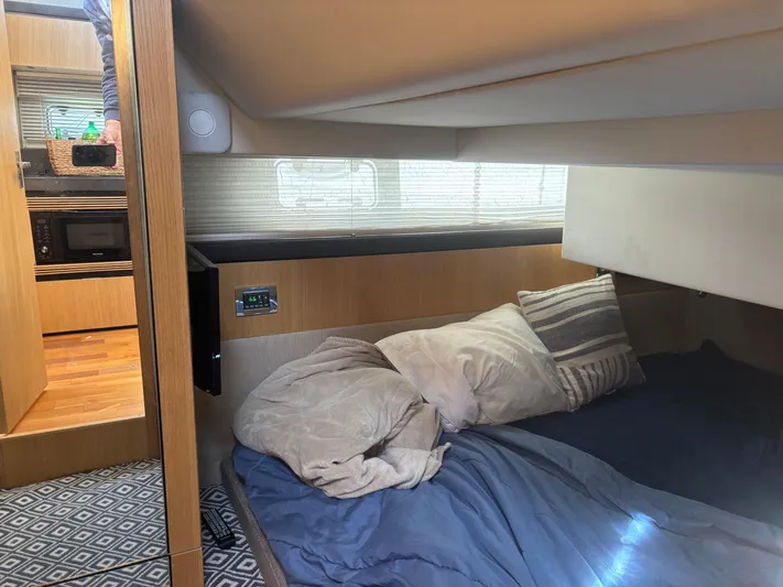 Sawbones Yacht Photos Pics Interior cabin of 2015 Fairline Squadron 42 yacht with cozy bedding and modern amenities.