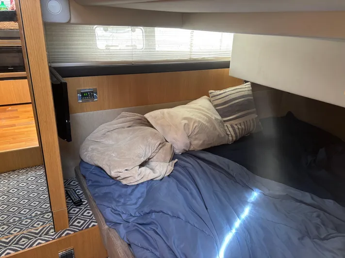 Sawbones Yacht Photos Pics Cozy cabin interior of 2015 Fairline Squadron 42 yacht with bed and pillows.