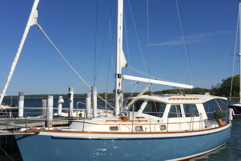 Spirit Yacht Photos Pics 2001 Cabo Rico Northeast 400 sailboat docked at a marina under clear blue skies.