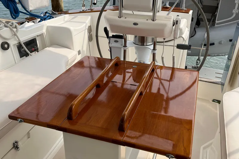 Spirit Yacht Photos Pics Cockpit of 2001 Cabo Rico Northeast 400 sailboat with polished wooden table and steering wheel.