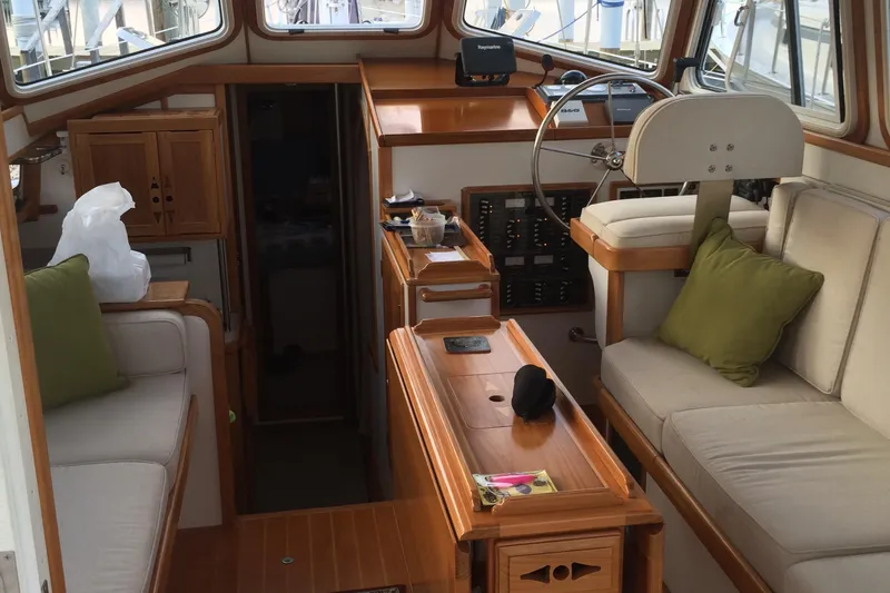 Spirit Yacht Photos Pics Interior of 2001 Cabo Rico Northeast 400 yacht with wooden furnishings and steering wheel.