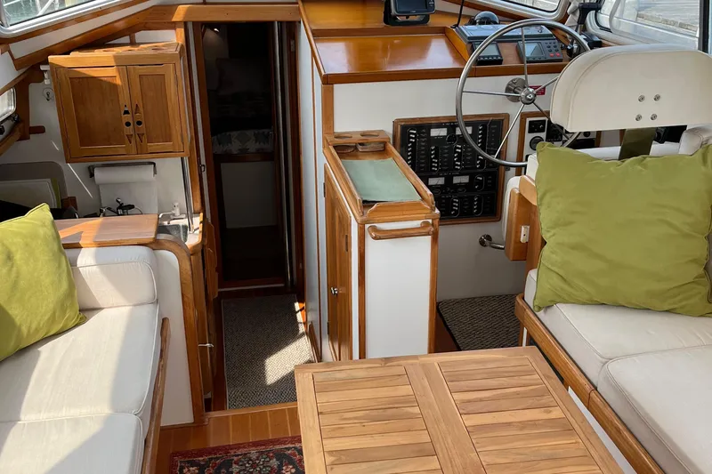 Spirit Yacht Photos Pics Interior of 2001 Cabo Rico Northeast 400 yacht with wooden accents and green cushions.