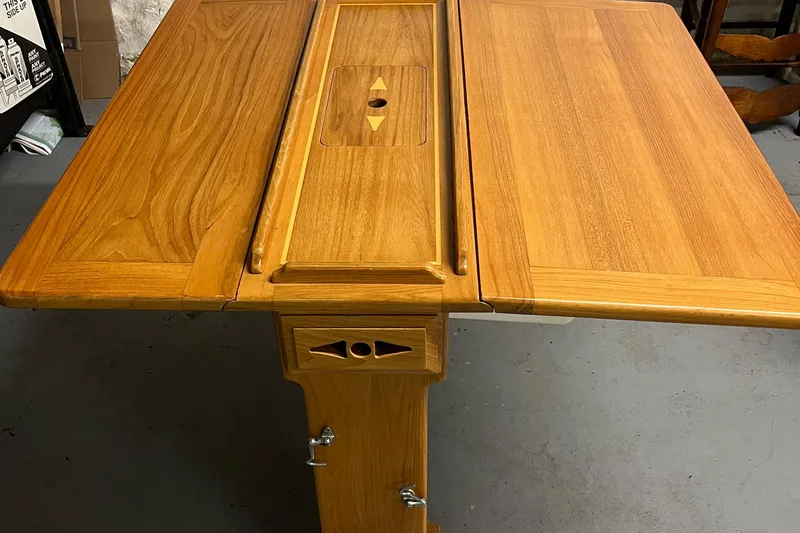 Spirit Yacht Photos Pics Wooden table from a 2001 Cabo Rico Northeast 400 yacht, featuring a foldable design.